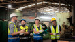 © pornchai - Professional Caucasian manager engineer in safety uniform is training industry factory worker, workshop factory operator, mechanical engineering team production in heavy industrial manufacture factory