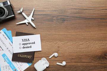 Wall Mural - Flat lay composition with passport, toy plane and tickets on wooden table, space for text. Visa receiving