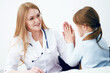 © khmelev - Creative professional female pediatric giving her little patient a high five