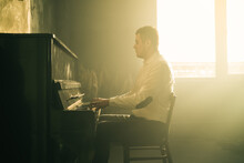 Composer Man Play On The Old Piano. Keyboards. Performance On The Concert. Musician Plays. Cinematic Photo With Smoke.
