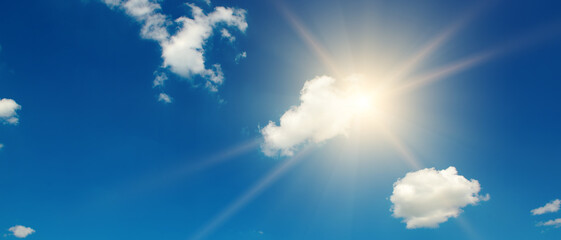 Wall Mural - blue sky with white clouds and bright sun