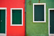Scenic view of red and green buildings with wooden windows in Burano, Venice, Italy