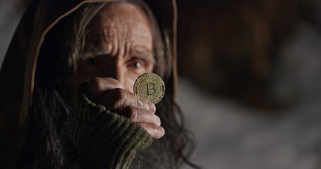 Wall Mural - homeless beggar pick up bitcoin and frown face expression. useless coin concept.
