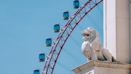 Sticker - Scenic view of an animal statue with a Ferris Wheel in the background