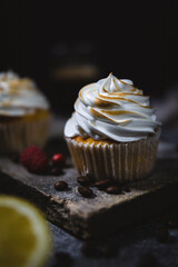 Sticker - Vertical closeup of a delicious small cupcake with a white topping and coffee beans on the bottom