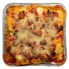 Homemade meat lasagna in an aluminum pan isolated on white