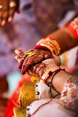 Sticker - Closeup of hands with henna tattoos during an Indian traditional wedding ceremony, kanyadan ritual