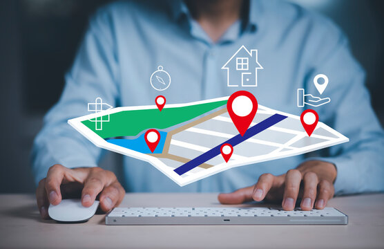 Businessman hand holding virtual world and model map with location point , GPS app, icon Travel maps and find places in the online system, all screen graphics are generated,Searching for travel goals.