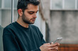 © carballo - portrait of young man with mobile phone in the street