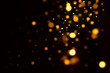 Festive golden luminous background with lights bokeh. Abstract glowing bokeh lights