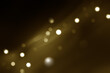 Festive golden luminous background with lights bokeh. Abstract glowing bokeh lights