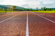 Image of new outdoor running track taken from a low perspective with clouds and hills in the background.