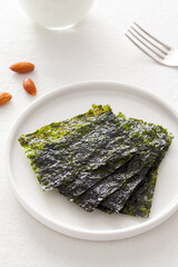 Set of nori sheets in a plate on white table.