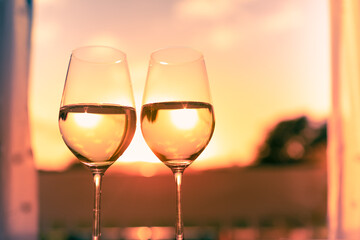 Wall Mural - Pair on wine glasses in a beautiful sunset setting