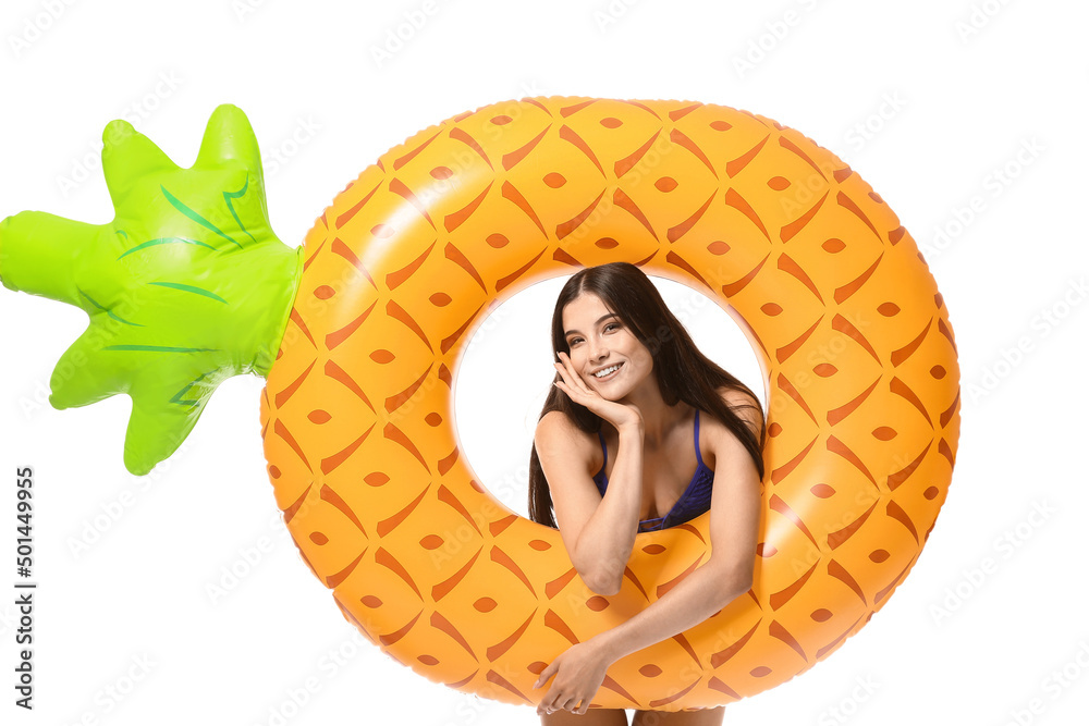 Attractive young woman with inflatable ring on white background