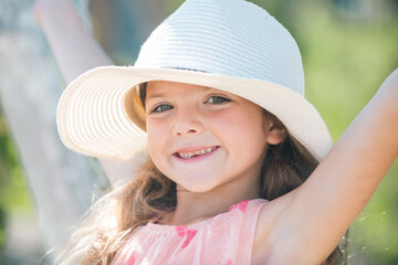 Summer kids girl outdoor, child cute face. Summer vacation and happy childhood. Emotional portrait of a cheerful and positive smiling teen girl.