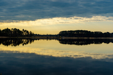 Wall Mural - sunset over the lake, the sunset over the water, the clouds at sunset, reflection