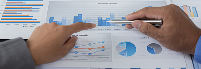 Brainstorm team, Marketers and financial accountants are discussing and analyzing charts to plan strategies to meet customer needs, Business success concept.