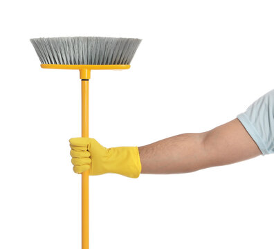 Young man with yellow broom on white background, closeup