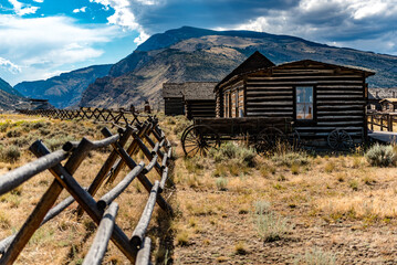 Wall Mural - Old western house in a field with mountains in the background in Cody, Wyoming