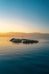 Poster - Vertical shot of a boat in Lake Geneva in Lausanne city, Switzerland