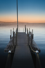 Vertical Photo Of A Pier In Lake Geneva In Lausanne City At Sunset, Switzerland
