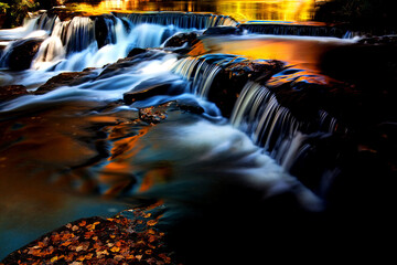 Beautiful landscape view of Bond Falls with dusk colors on its water in Michigan, United States