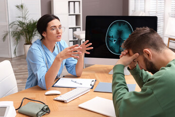 Poster - Neurologist consulting patient at table in clinic