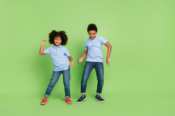 Wall Mural - Full length body size view of attractive cheerful pre-teen people dancing having fun isolated over green color background