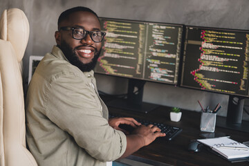 Wall Mural - Profile side view portrait of attractive cheerful experienced smart clever guy editing data at workplace workstation indoors