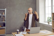 © Studio Romantic - Serious professional business man on speakerphone. Bald middle aged entrepreneur standing by working desk table with notebook PC in home office, holding phone, recording thought, idea or voice message