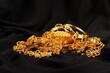 Lots of golden luxury jewels over a black background