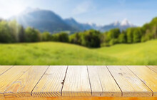 Wooden Table Top On Blur Mountain And Grass Field.Fresh And Relax Concept.For Montage Product Display Or Design Key Visual Layout.View Of Copy Space.