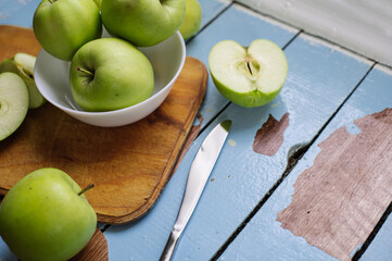 Wall Mural - Fresh raw green apples on the wooden background. Healthy food. Juicy fruits for all