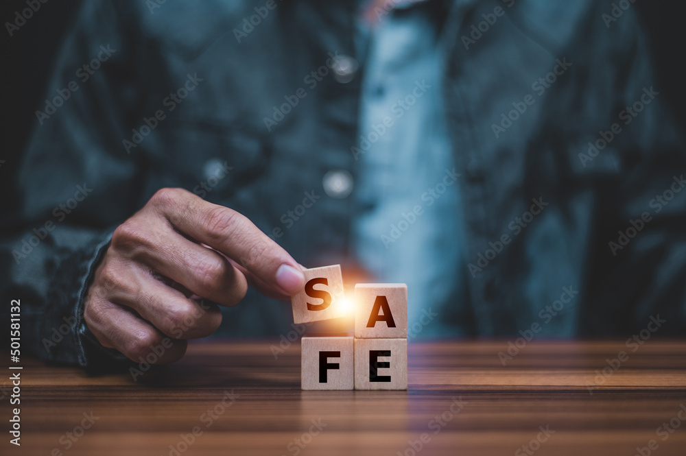 Hand touch wood cube safe concept for safety safe zone or safe care safe home insurance