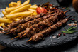 Grilled meat skewers, shish kebab with onion and sweet pepper. Georgian cuisine. hearty lunch or dinner, banner, menu, recipe place for text, top view