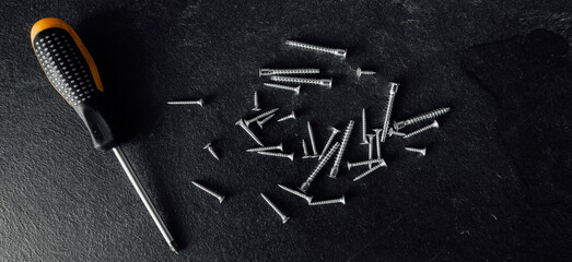 Poster - Screwdriver and nails on wooden background