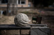 An old abandoned ball near an abandoned building. Abandoned sports base. Old dirty ball from the times of the USSR.