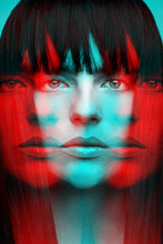 Woman With Bob Haircut Long Dark Hair Close-up Fashion Portrait In RGB Color Split. RGB Effect Make Reflection Of Model Face In Red And Blue Colors. Abstract And Futuristic Looking Style