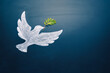 Leinwandbild Motiv Dove of peace concept. Symbol of freedom and international day of peace. Chalk painted dove with olive branch