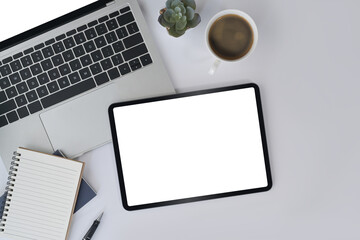 Wall Mural - Digital tablet, laptop, notebook, succulent plant and coffee cup on white office desk. Top view.