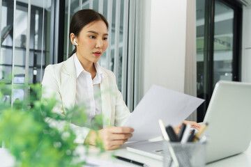 Confidence woman concept, Businesswoman read financial document to calculate profit of business