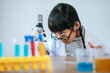 © Johnstocker - girls doing science experiments in the lab