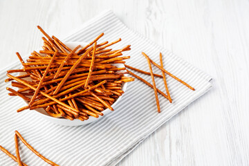 Wall Mural - Crunchy Salty Baked Pretzel Sticks in a Bowl, low angle view. Copy space.