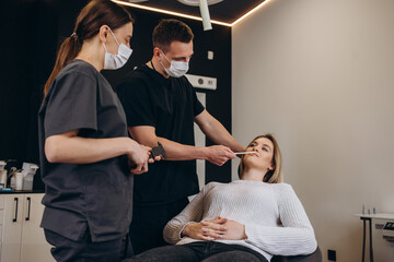 Wall Mural - Young woman having meeting with plastic surgeon