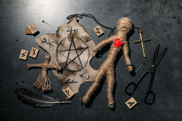 Wall Mural - Voodoo dolls and ceremonial items on grey table, flat lay