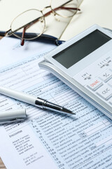 Wall Mural - Calculator, glasses, documents and stationery on table, closeup. Tax accounting