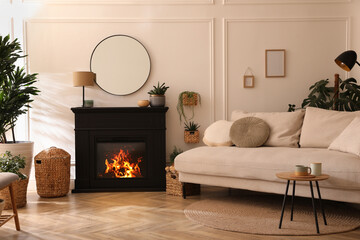 Wall Mural - Stylish living room interior with electric fireplace, comfortable sofa and beautiful decor elements