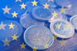 Leinwandbild Motiv Double exposure of European Union flag and coins on wooden table, closeup view