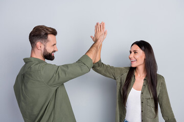 Aufkleber - Portrait of attractive cheerful couple best successful team giving five isolated over grey pastel color background
